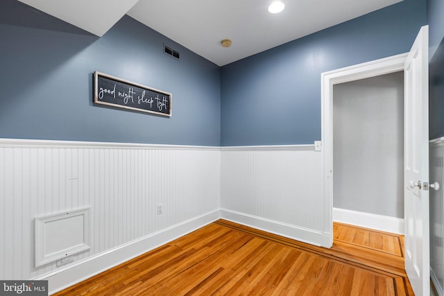 unfurnished room with wood-type flooring