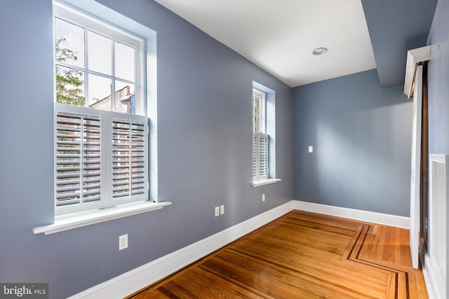 unfurnished room with hardwood / wood-style floors and a wealth of natural light