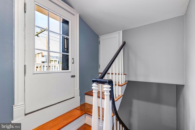 stairs with vaulted ceiling