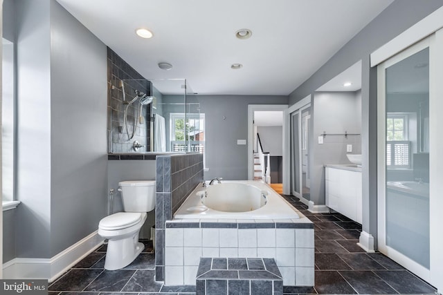 full bathroom featuring vanity, plenty of natural light, toilet, and separate shower and tub