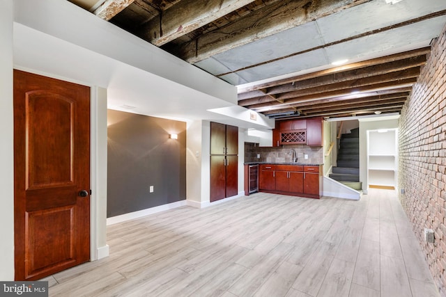 interior space with wine cooler, decorative backsplash, brick wall, and light wood-type flooring