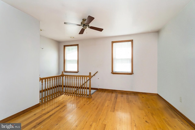 spare room featuring ceiling fan and light hardwood / wood-style floors