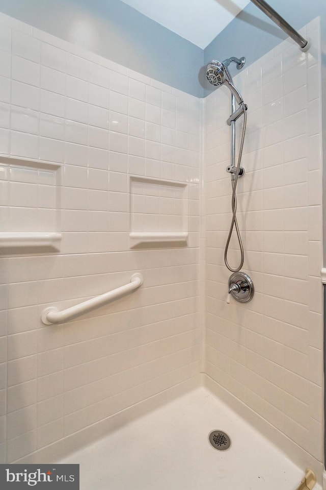 bathroom with tiled shower