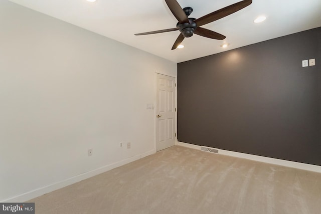 unfurnished room with ceiling fan and light colored carpet