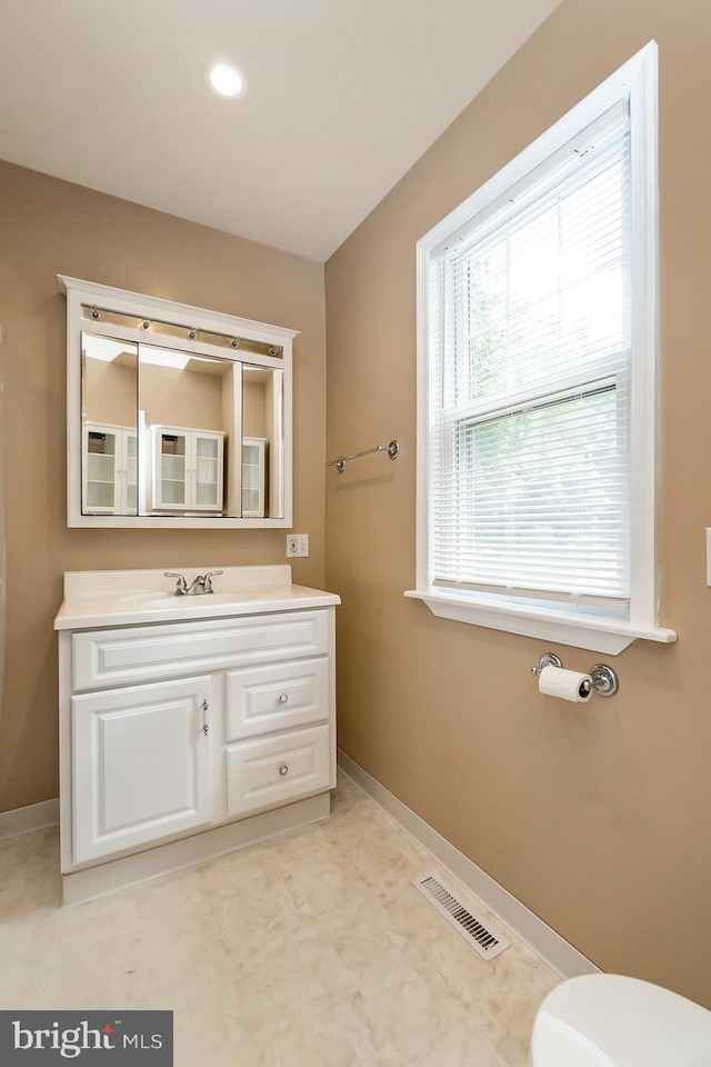 bathroom featuring toilet and vanity