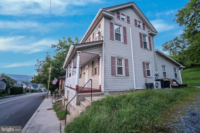 view of side of property with ac unit