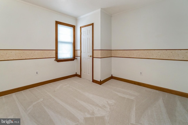 carpeted spare room with crown molding