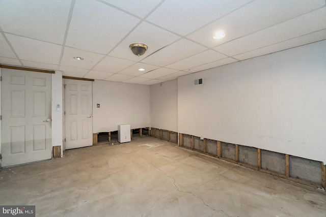 basement with a paneled ceiling