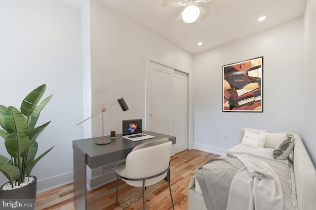 office space with ceiling fan and light hardwood / wood-style flooring