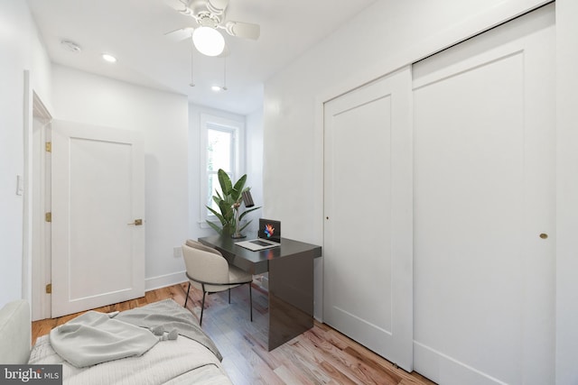 home office featuring ceiling fan and light hardwood / wood-style flooring