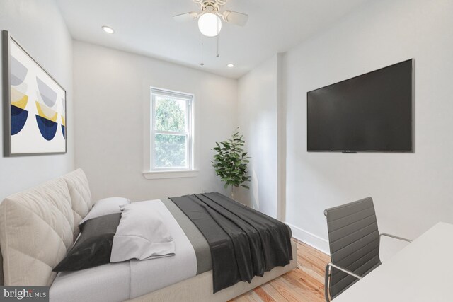 bedroom with hardwood / wood-style floors and ceiling fan