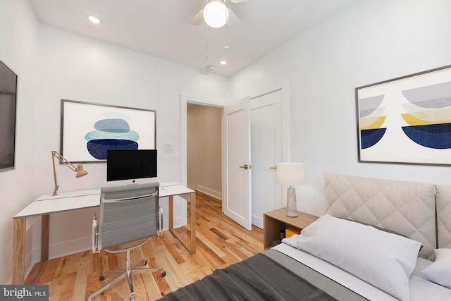 bedroom with ceiling fan and light hardwood / wood-style floors