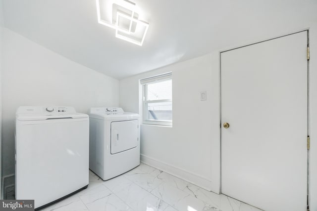 clothes washing area with washer and clothes dryer