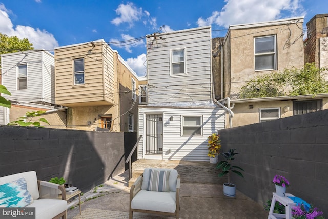 rear view of house featuring a patio and outdoor lounge area