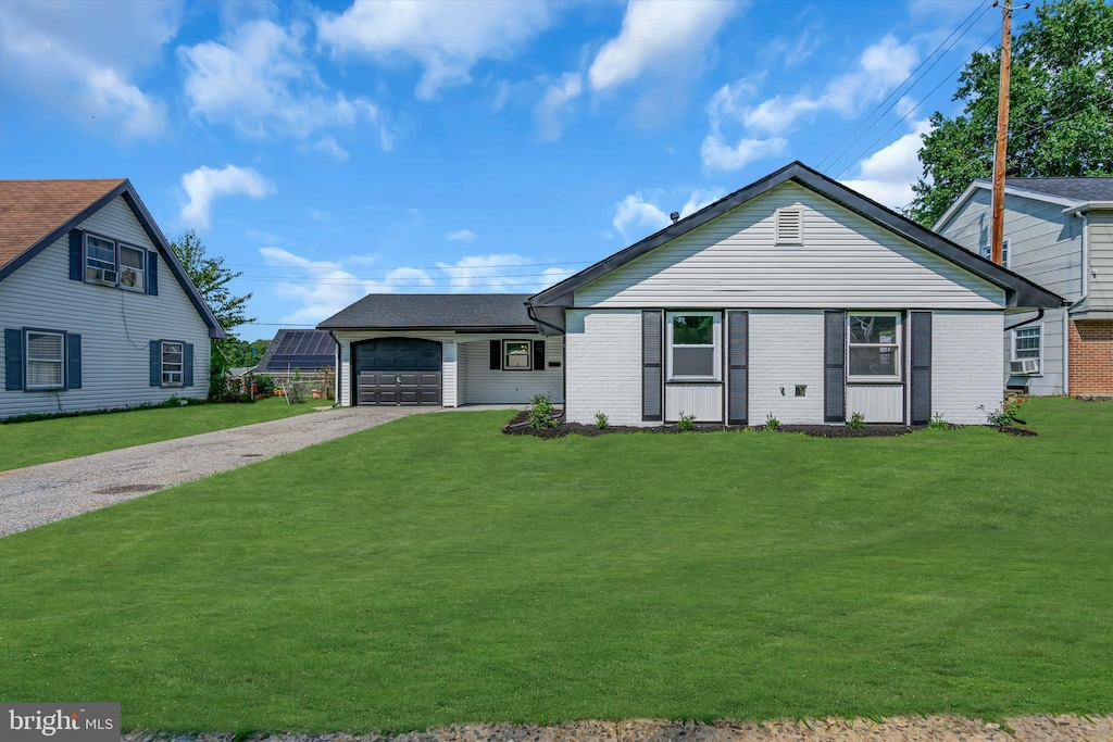 view of front of home with a garage and a front lawn