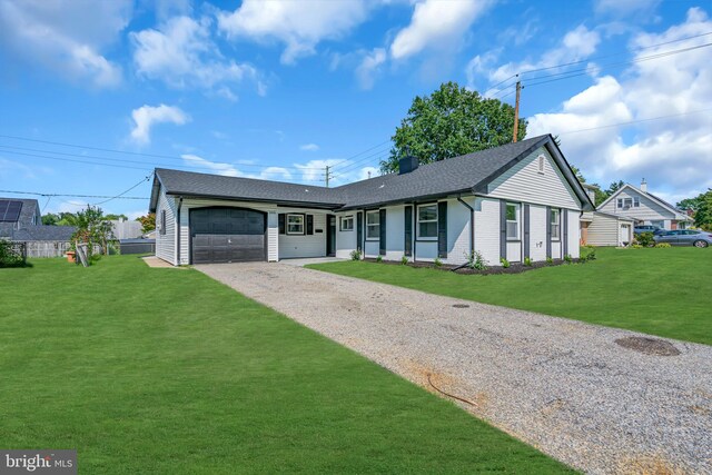 ranch-style home featuring a front yard and a garage