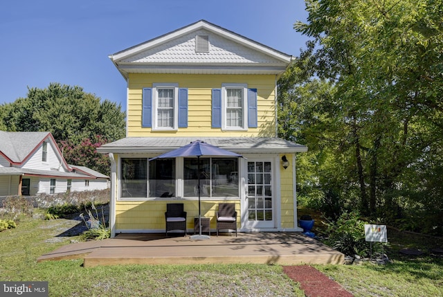 exterior space featuring a sunroom and a front yard