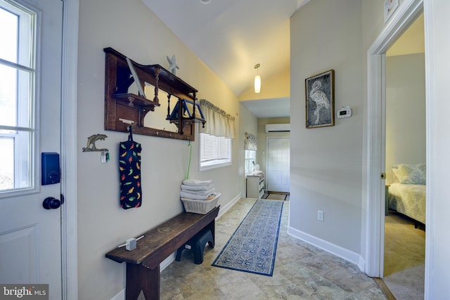 mudroom featuring light tile patterned floors, lofted ceiling, and a healthy amount of sunlight