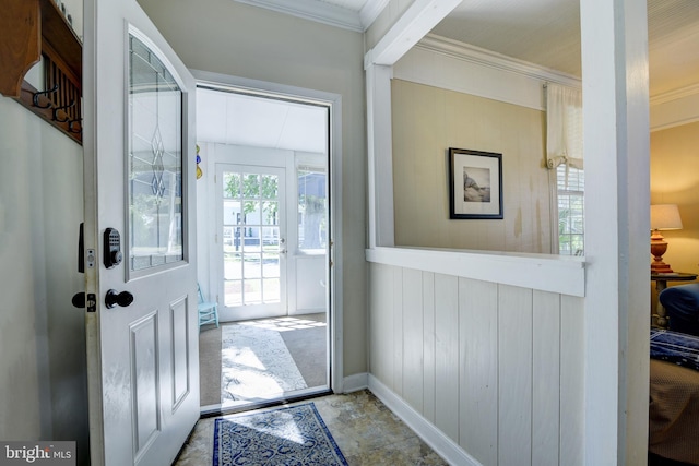 doorway with ornamental molding and light tile patterned floors