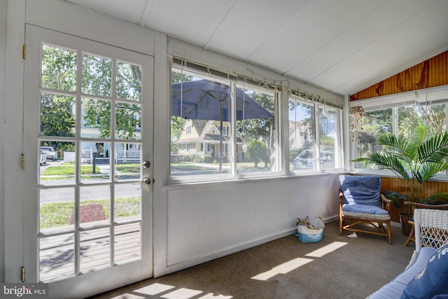 sunroom / solarium featuring vaulted ceiling