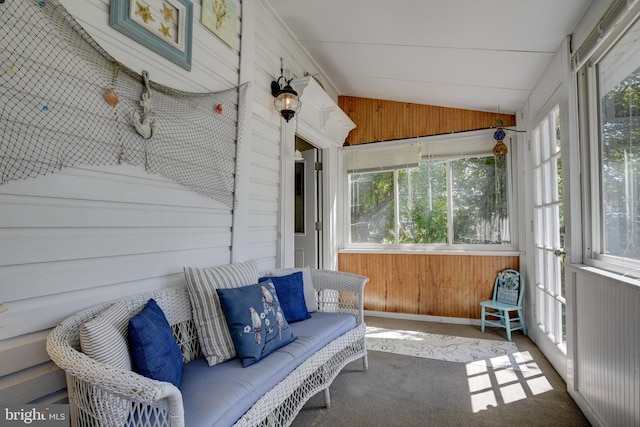 sunroom / solarium featuring vaulted ceiling