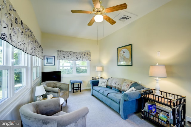 living room with plenty of natural light, ceiling fan, and carpet flooring