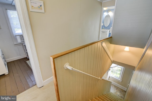 stairway with sink and wood-type flooring