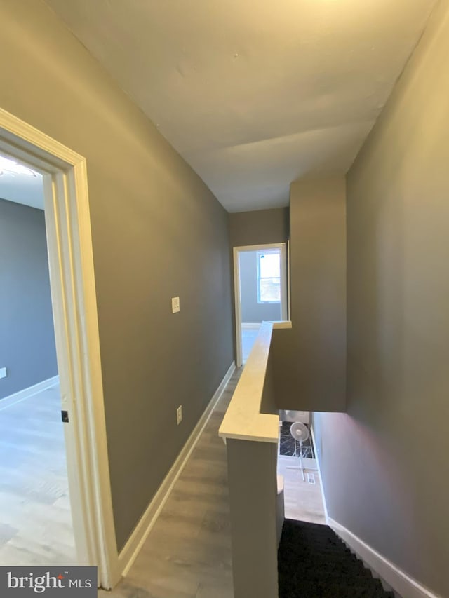 corridor with hardwood / wood-style floors