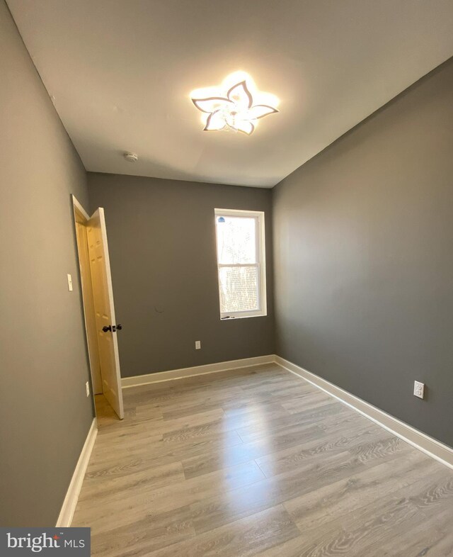 empty room with wood-type flooring