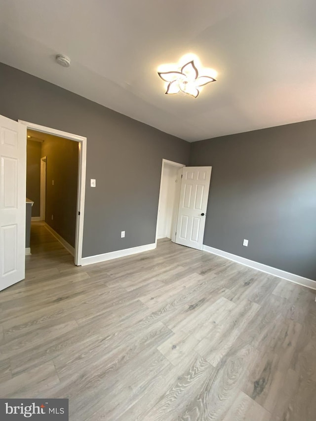 unfurnished bedroom with hardwood / wood-style flooring