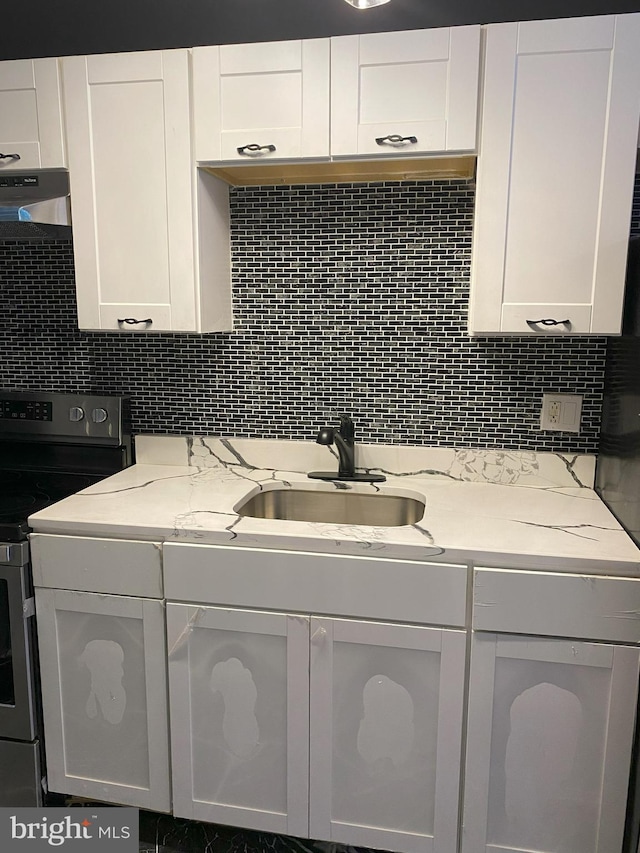 1636 Fillmore St, Philadelphia, PA 19124 - kitchen with a sink, white cabinets, ventilation hood, stainless steel electric range, and decorative backsplash