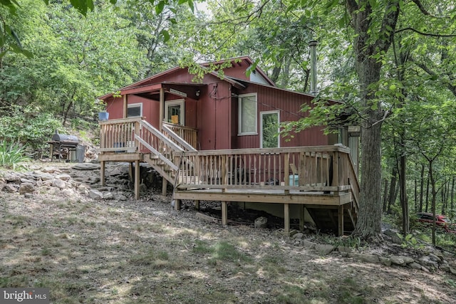 back of house featuring a deck