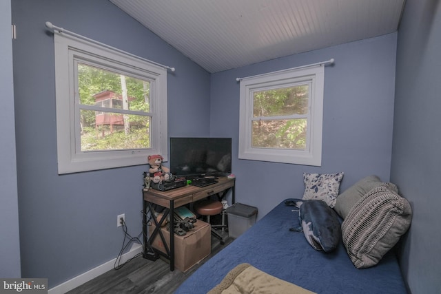 bedroom with vaulted ceiling and dark hardwood / wood-style floors