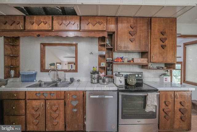 kitchen featuring sink, tile counters, and stainless steel appliances