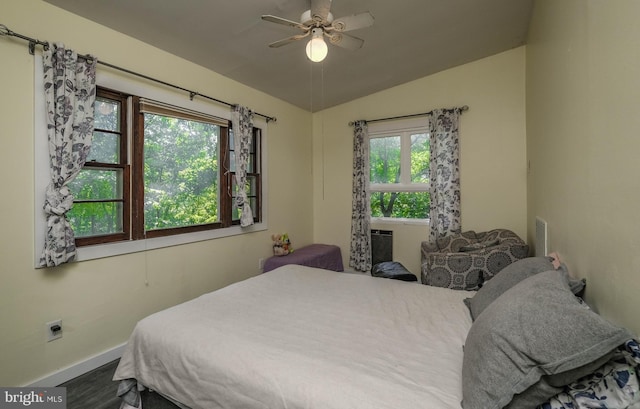 bedroom with vaulted ceiling, hardwood / wood-style floors, and ceiling fan