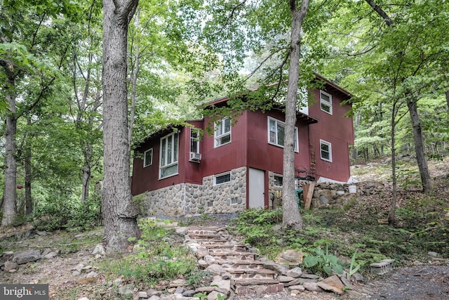 view of side of home featuring cooling unit