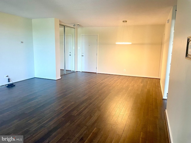 spare room featuring dark hardwood / wood-style flooring