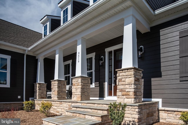 view of exterior entry with a porch