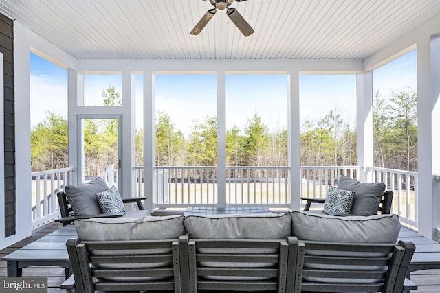 sunroom / solarium featuring ceiling fan