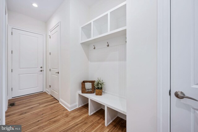 mudroom with light hardwood / wood-style floors