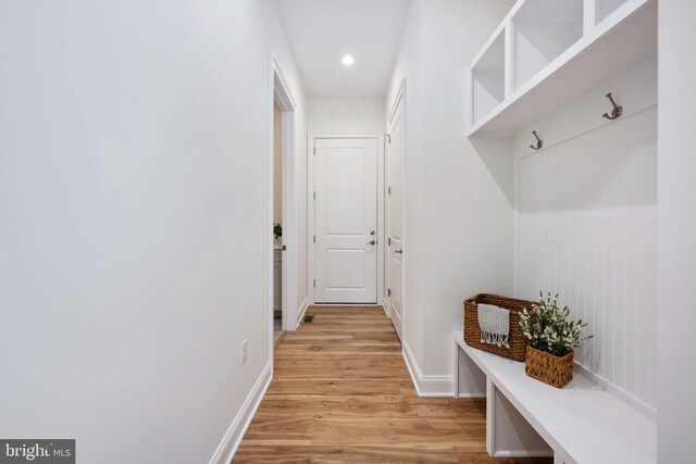 mudroom with light hardwood / wood-style flooring