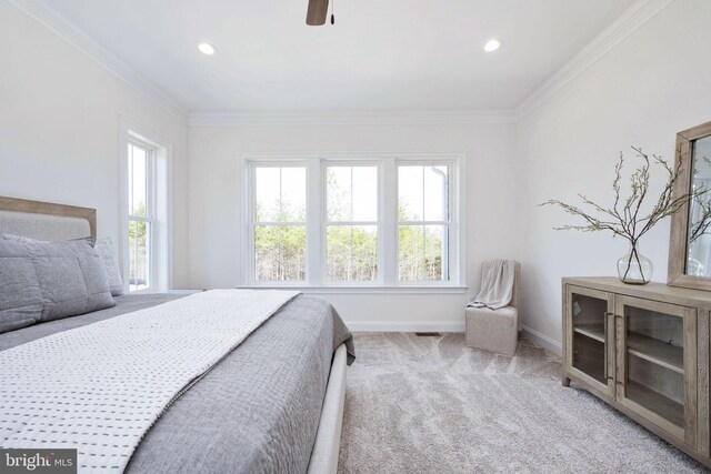 bedroom with ceiling fan, crown molding, and light colored carpet