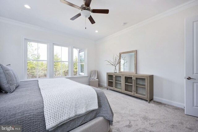 carpeted bedroom featuring ceiling fan, multiple windows, and crown molding