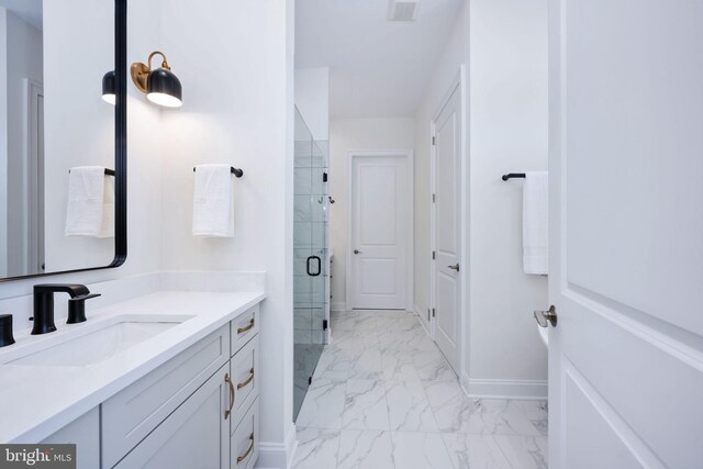 bathroom with tile patterned floors, a shower with door, and vanity