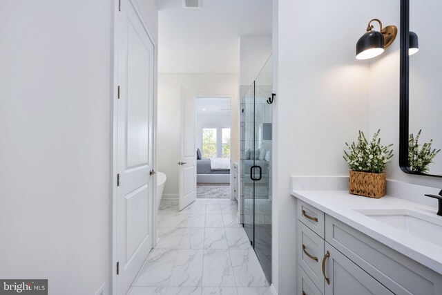 bathroom featuring tile patterned flooring, vanity, and a shower with shower door