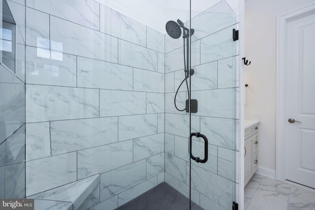 bathroom featuring tile patterned floors, a shower with door, and vanity