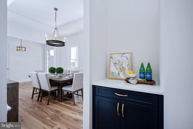 interior space featuring light wood-type flooring and an inviting chandelier