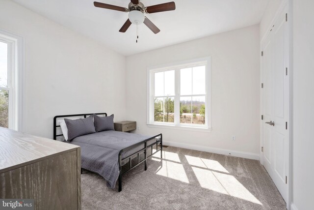 carpeted bedroom featuring ceiling fan