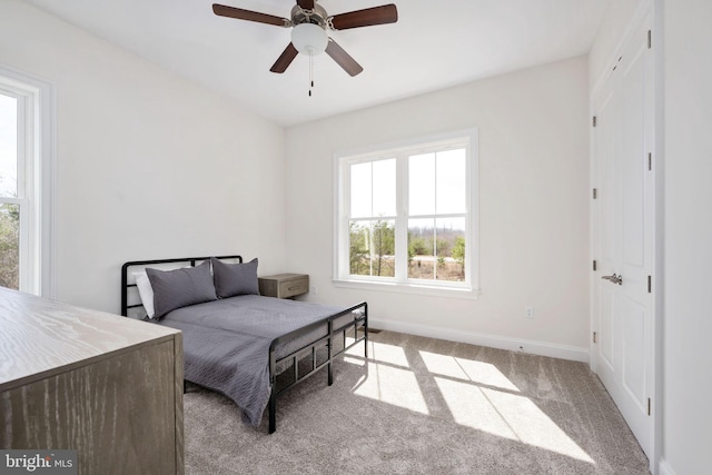 bedroom with light carpet and ceiling fan