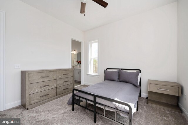 bedroom featuring carpet floors, ceiling fan, and connected bathroom